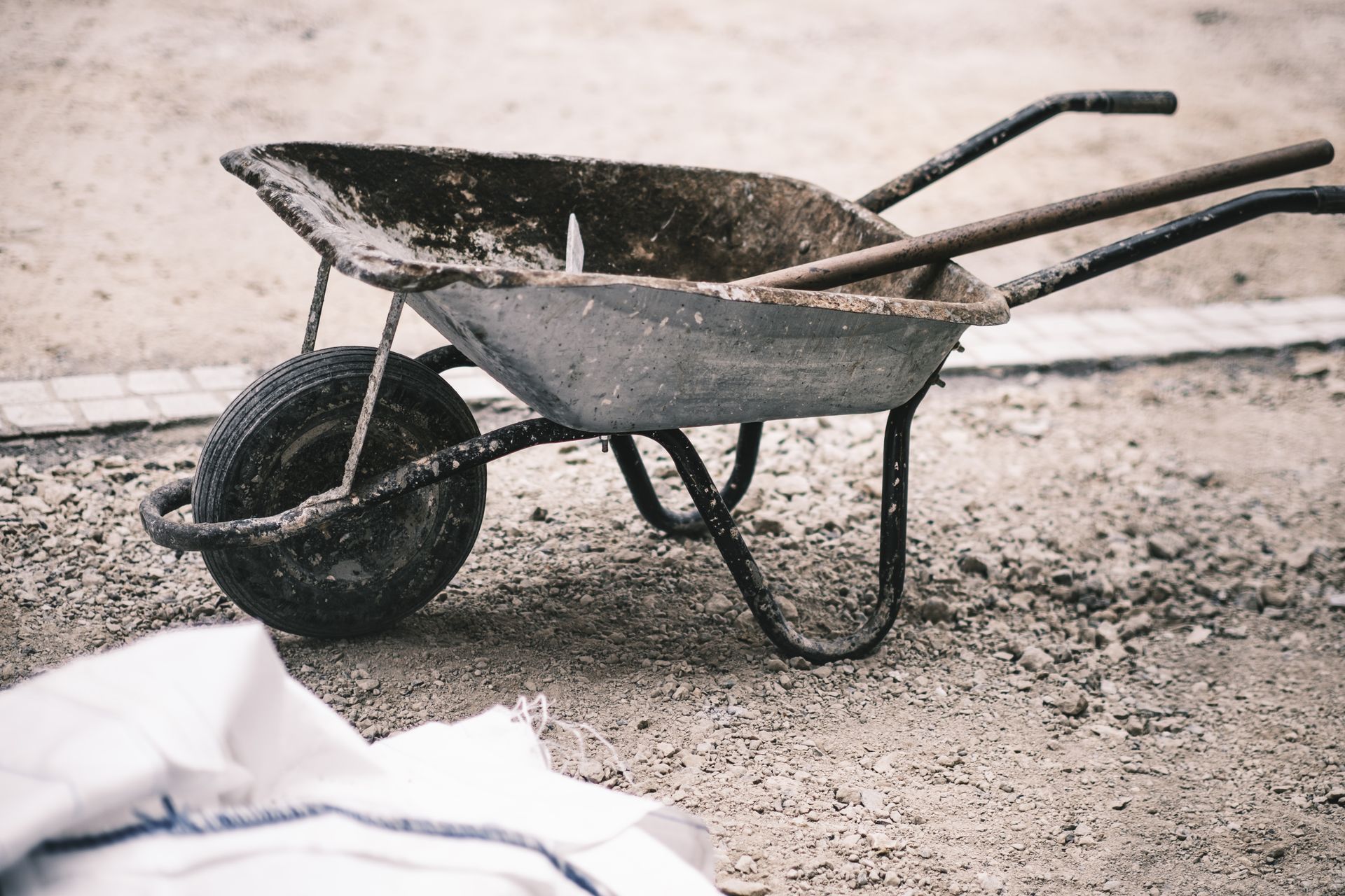 Gravel work area with a wheelbarrow before the wall was built