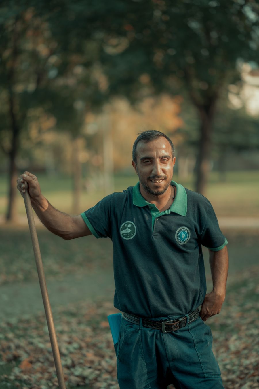 Owen Brooks holding a rake in an autumn garden